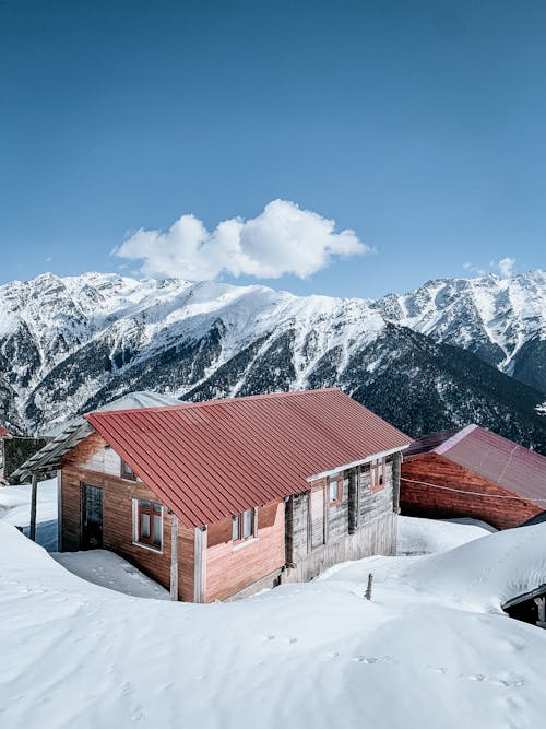 Wooden House near Snow Capped Mountains 