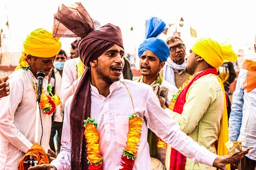 Men in Traditional Clothing With Turbans Singing
