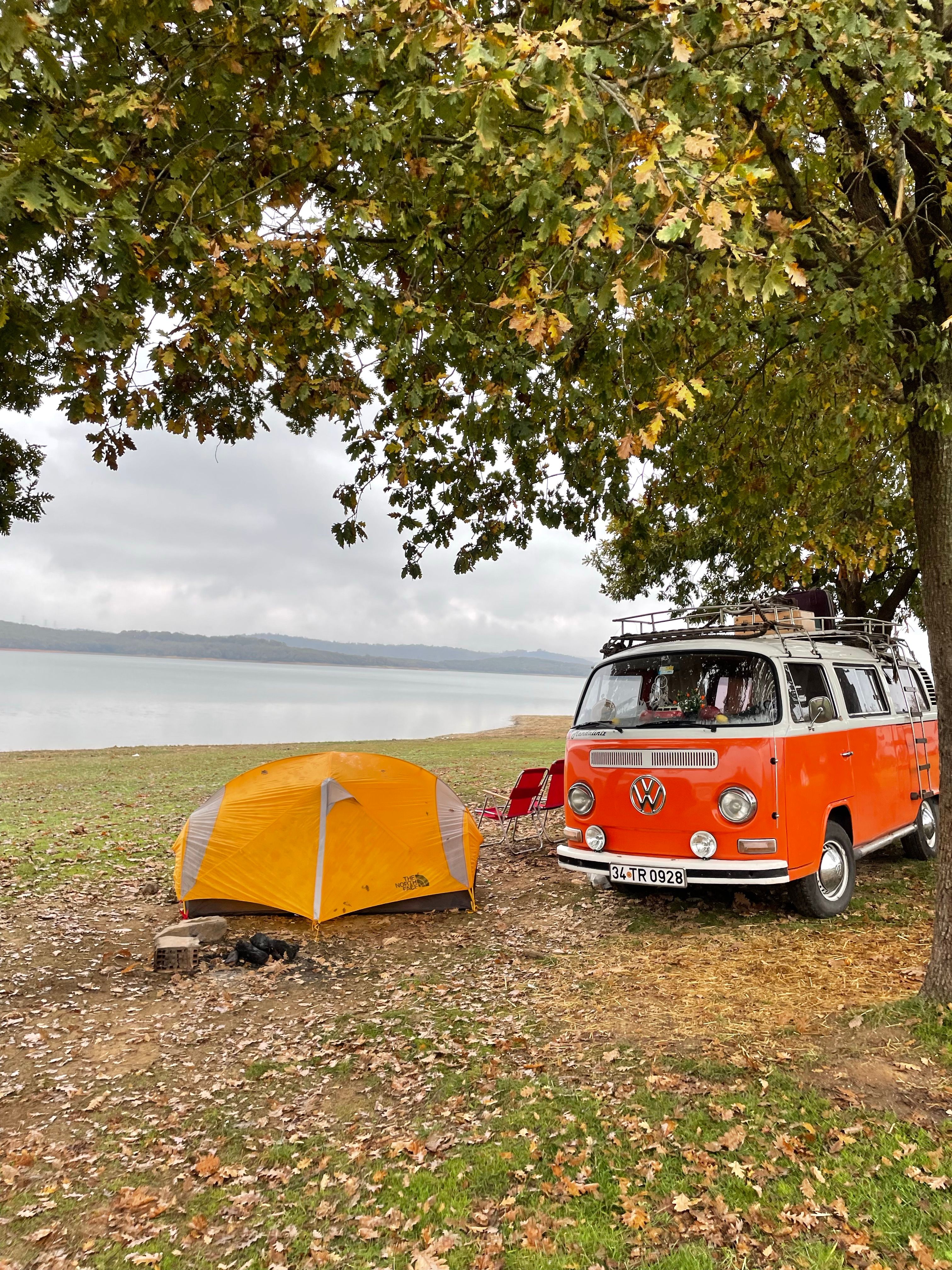 Red and White Van Parked Near a Yellow Tent · Free Stock Photo