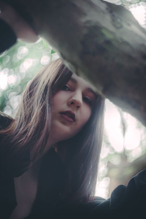 Free A serene portrait of a woman with natural lighting and bokeh effect. Stock Photo