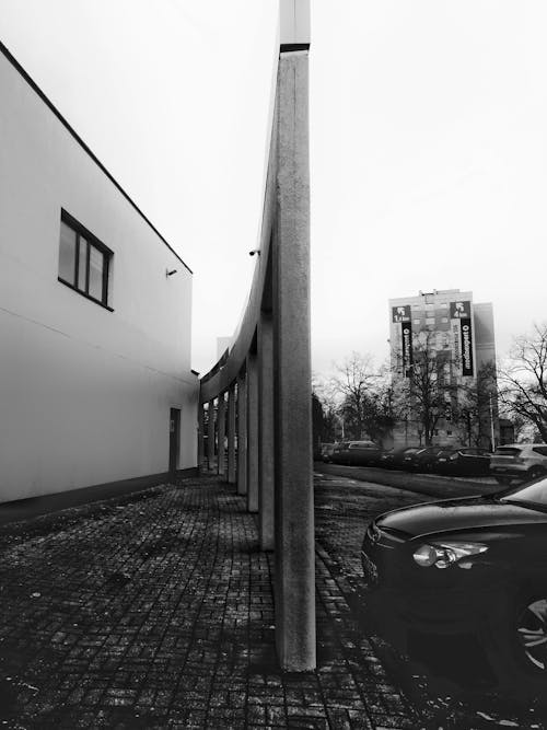 Parked Car by a Concrete Structure 