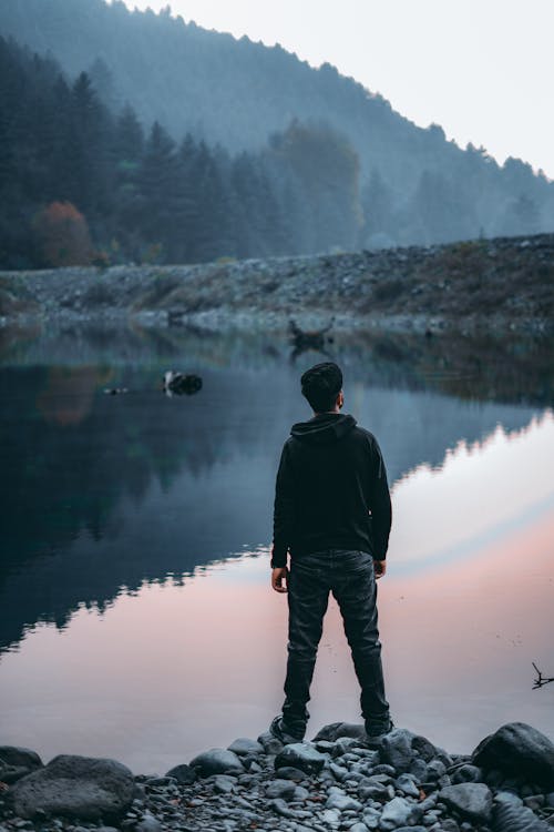 Man Standing in front of Lake