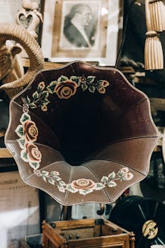 Close-up of a vintage phonograph horn with floral design, evoking nostalgia.