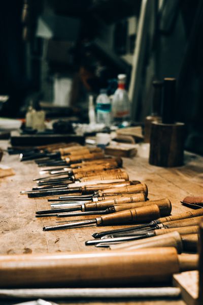 Row of carving chisels arranged on a workbench