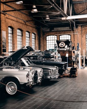 Explore this vintage car workshop in Berlin with classic vehicles in an industrial setting.