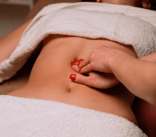 Masseur Giving Woman Stomach Massage