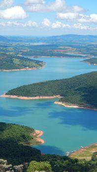 Captivating aerial view of Lake Furnas with lush green islands in Capitólio, Brazil.