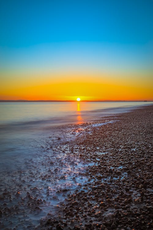 Foto profissional grátis de cair da noite, costa, crepúsculo