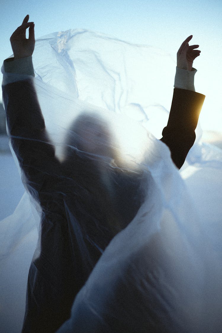 Woman Standing Under Sheer Fabric