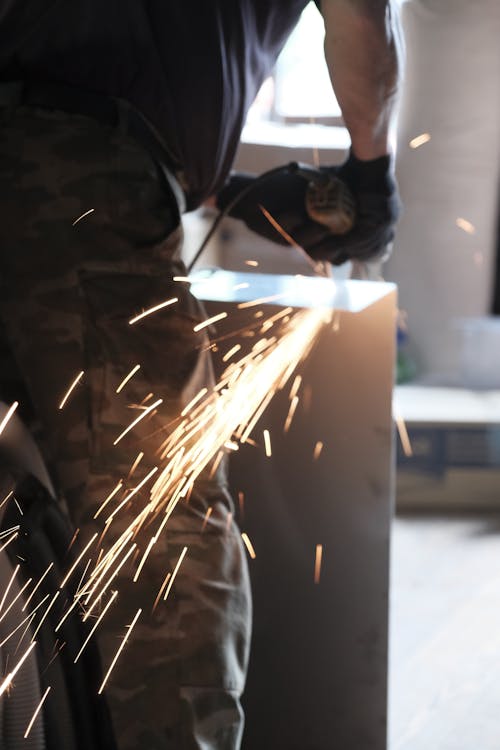 Free Person Grinding a Metal Stock Photo