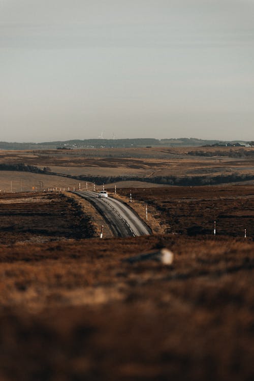 Car Driving on Freeway Across Plains