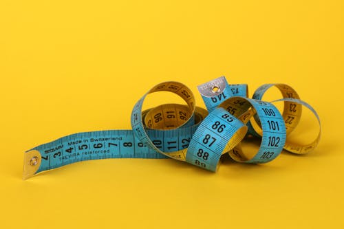 Blue Tape Measure on Yellow Surface