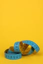 A Blue Tape Measure on a Yellow Background