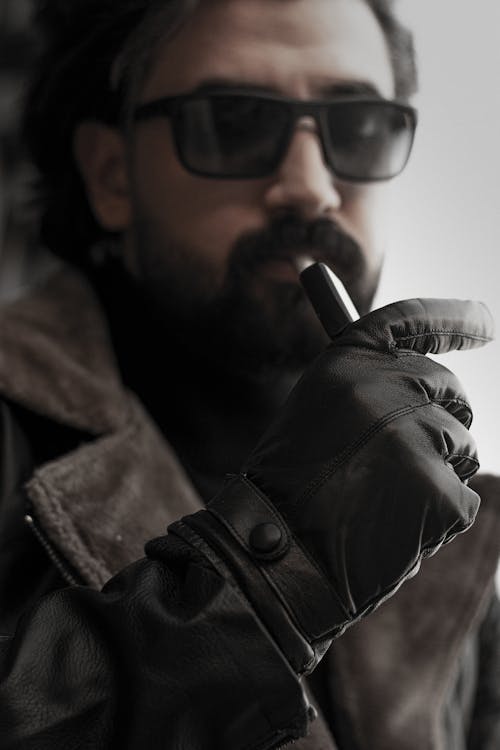 A Man Wearing a Brown Leather Jacket and Black  Gloves