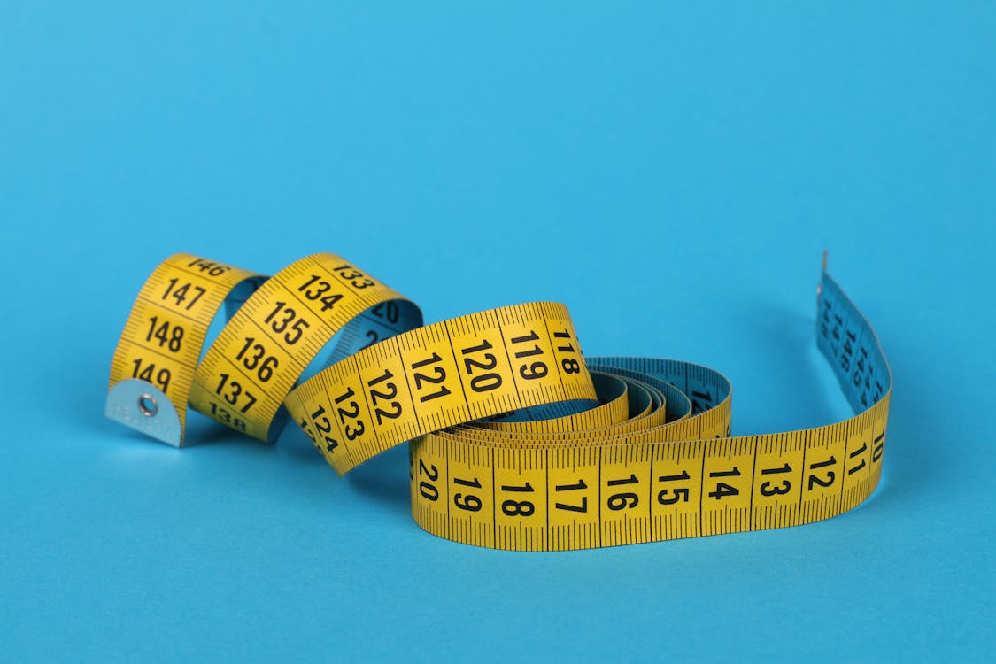 Tape Measure on Blue Surface · Free Stock Photo