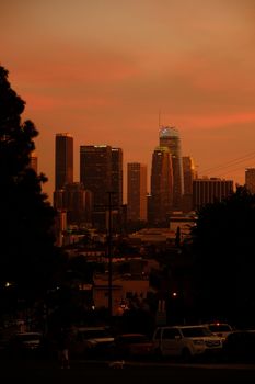 A captivating view of the Los Angeles skyline at sunset with vibrant colors and urban silhouettes.