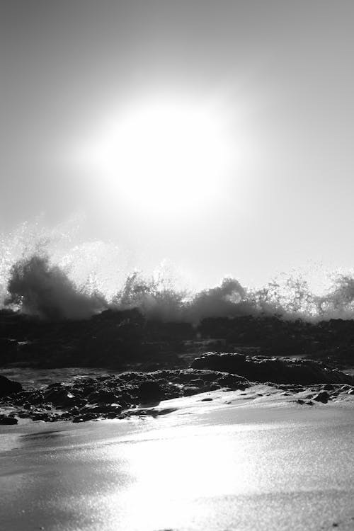 Grayscale Photo Crashing Waves on Bedrock