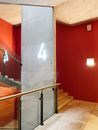 Stainless Steel Railings Near Red Wall