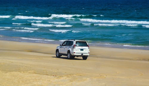 White Vehicle on Beach Sand