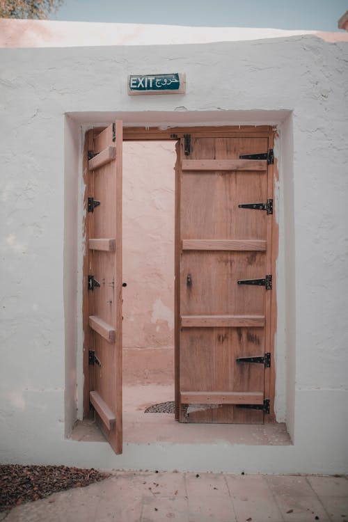 Brown Wooden Door on White Wall