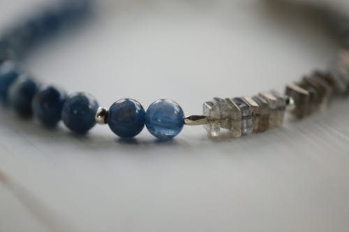 Free Blue Beaded Bracelet on White Surface Stock Photo