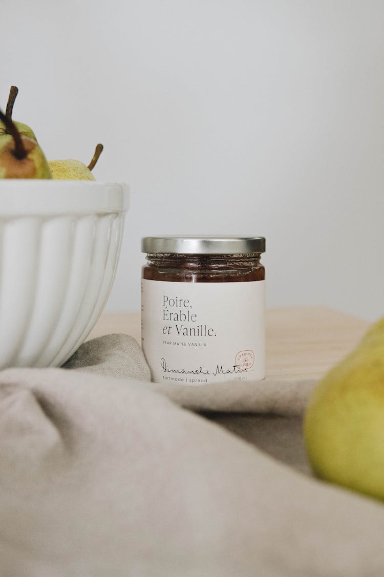 Jar Of Cosmetic Near Basket With Fruit