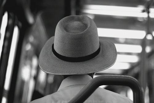 Grayscale Photo of a Person Wearing Hat