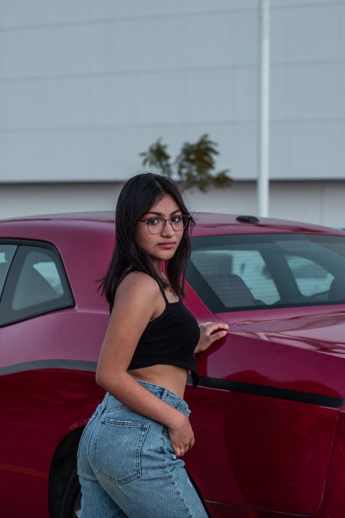 Portrait of a Woman Standing next to a Car · Free Stock Photo