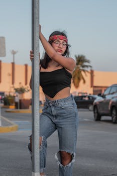 Young woman in casual fashion posing on a city street with a modern and stylish vibe.