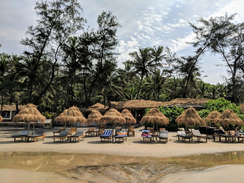 Beach chairs and huts on a Goa beach