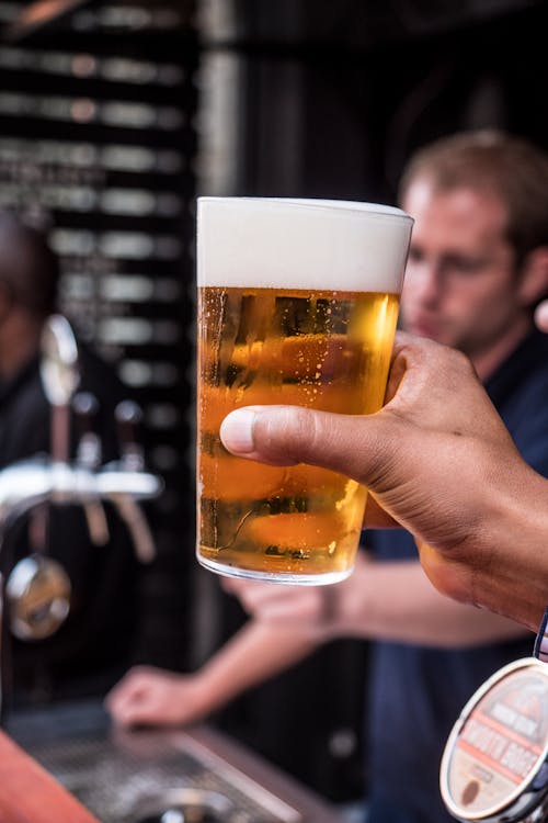 Free Person Holding Glass Filled With Liqour Stock Photo