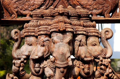 Free Detailed wood carving of a five-headed Ganesha sculpture. Captures artistic craftsmanship. Stock Photo
