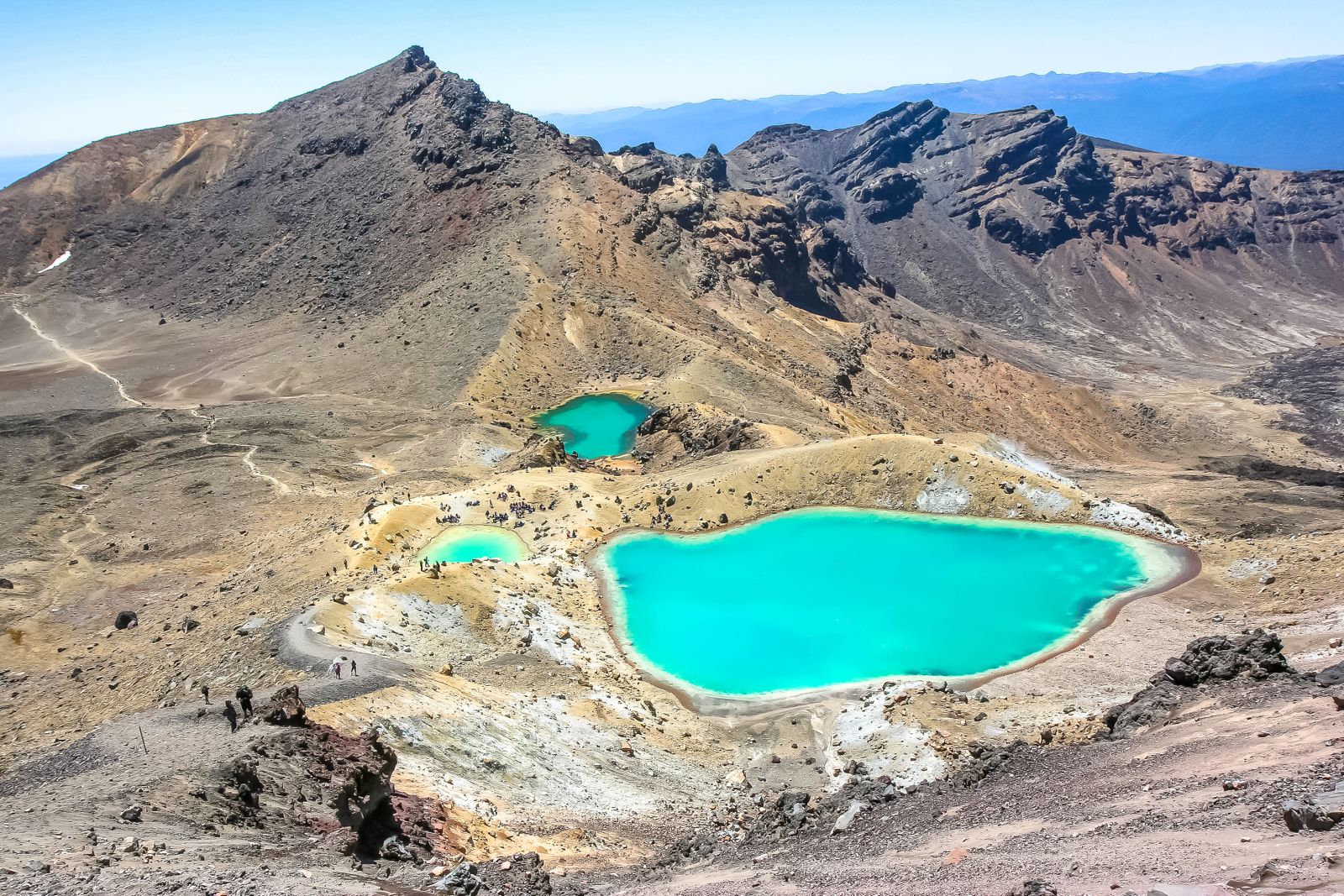 The vivid Emerald Lakes beside volcanic slopes on the Tongariro Alpine Crossing