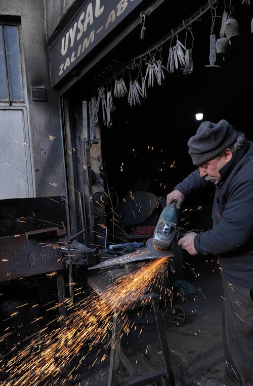 Blacksmith Grinding a Metal
