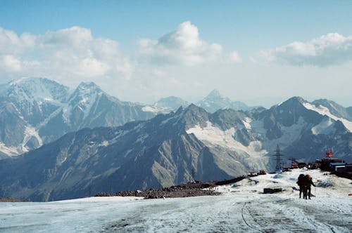 Snow-Covered Mountains under the Cloudy Sky