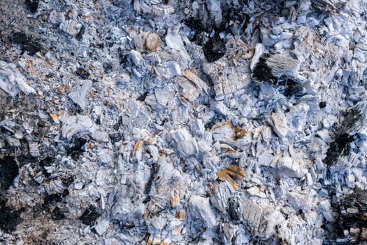 Close-up of ash and charred residue inside a firebox — creosote buildup explained
