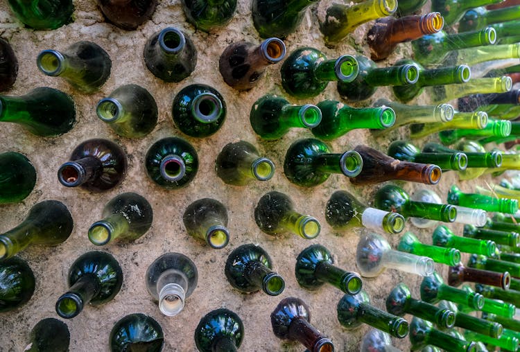 Colored Glass Bottles On Brown Sand 