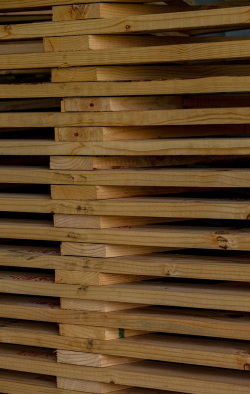 Stacked wooden planks in a yard