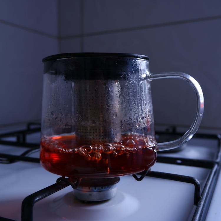 Clear Glass Pot With Red Liquid On Gas Stove