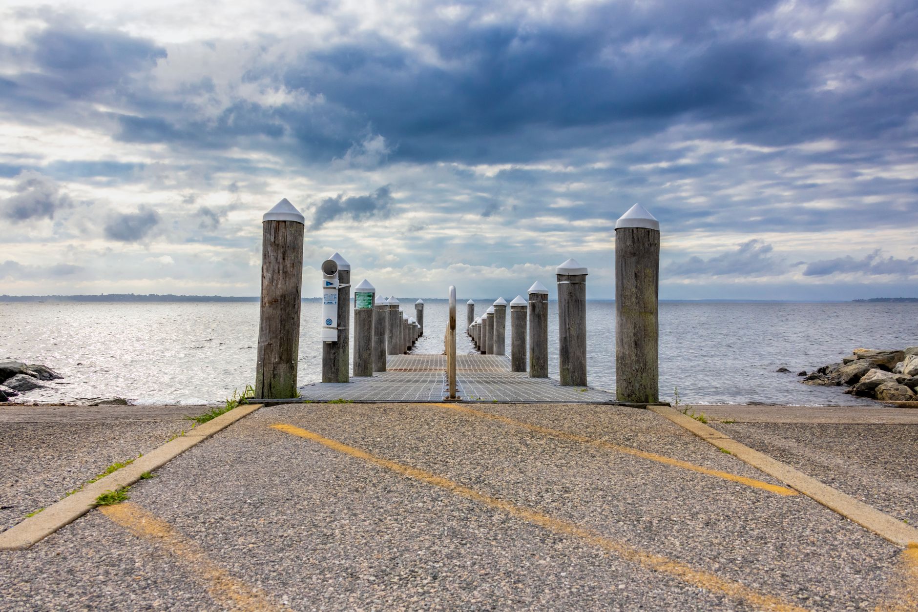 Idyllic view of a dock on a calm sea under a cloudy sky in Rhode Island, USA.