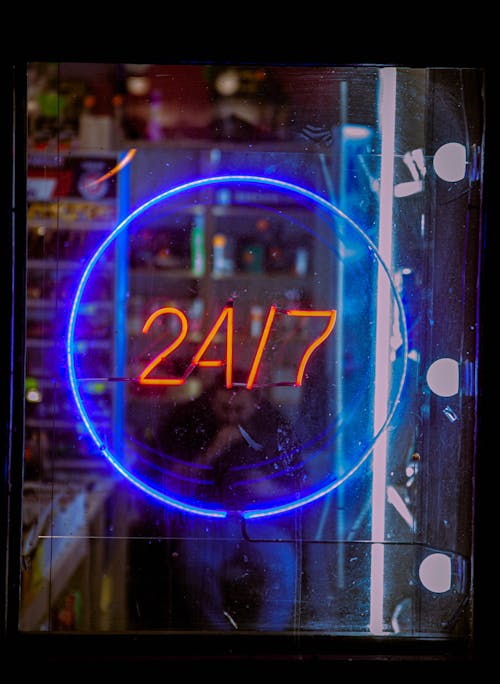 24/7 Sign on a Glass Door of a Pharmacy