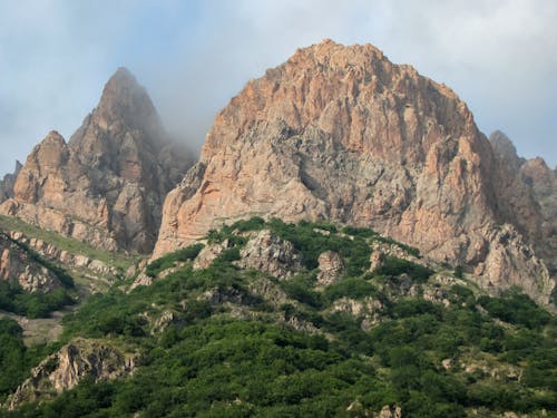 Brown Rocky Mountain Under White Sky