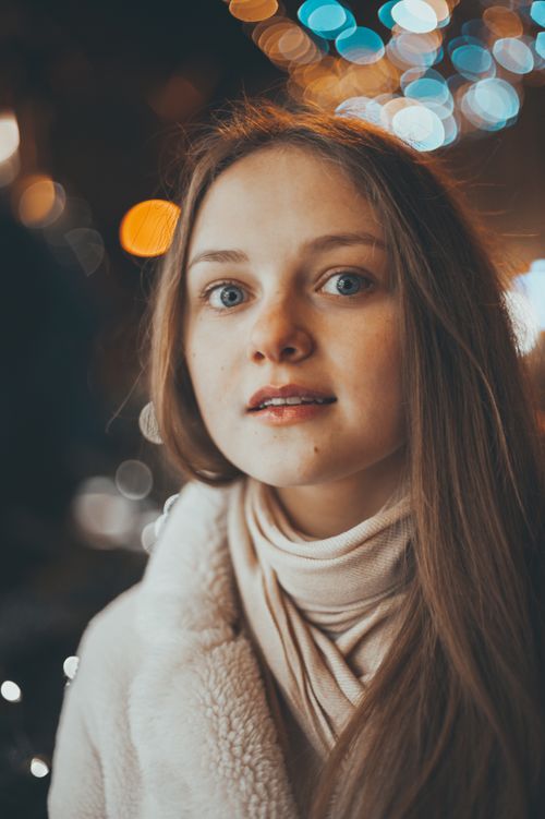 Free A captivating portrait of a woman in a winter setting with a beautiful bokeh background. Stock Photo