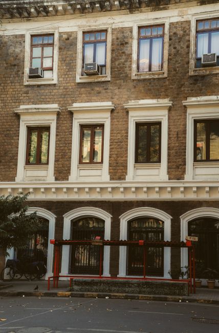 Elegant townhouse exterior featuring a brick facade and classic windows in an urban setting.