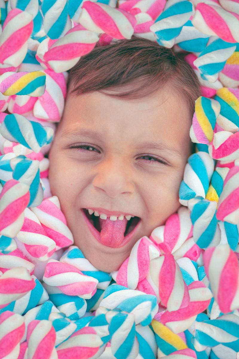 Smiling child surrounded by marshmallows