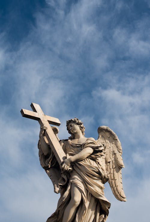 Free Angel Carrying the Cross Statue Stock Photo