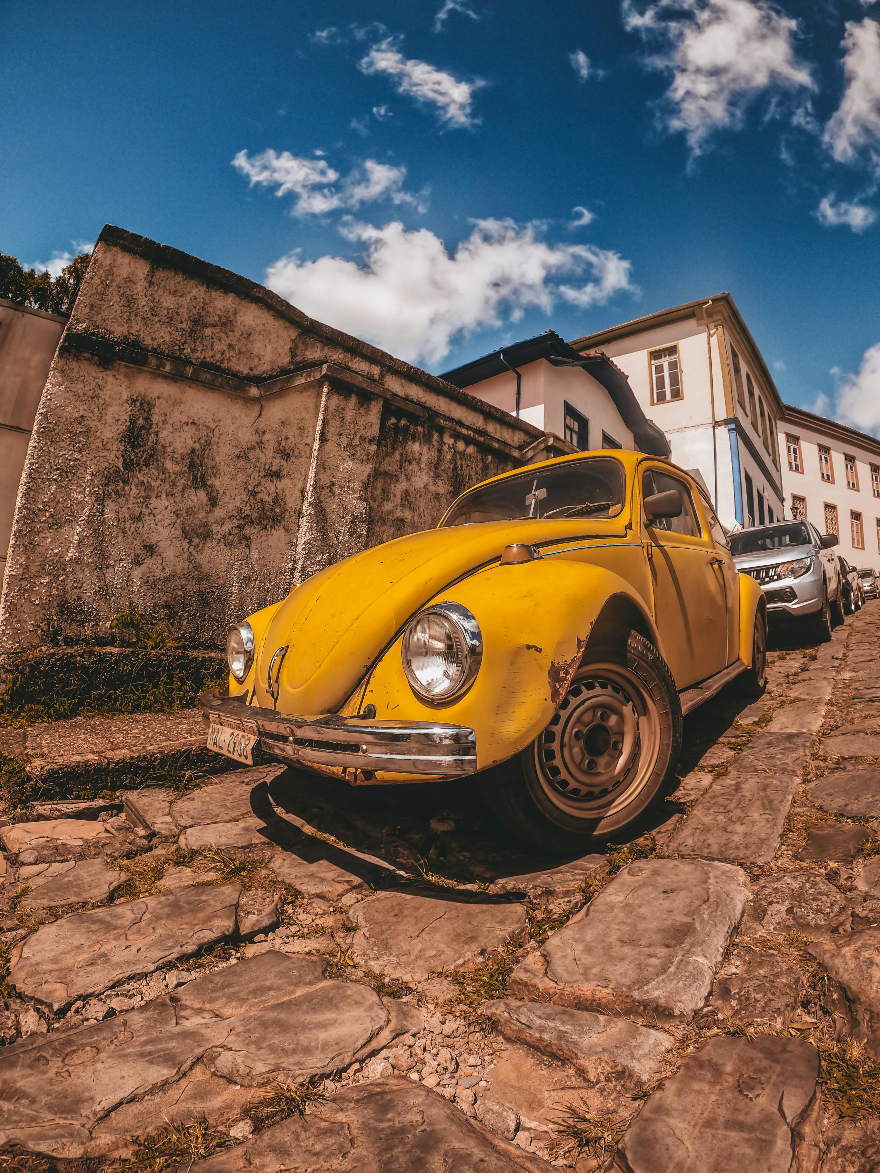 A charming vintage Volkswagen Beetle parked on a cobblestone street in Diamantina, Brazil.