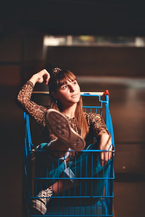 Free Woman Sitting Inside a Shopping Cart Stock Photo