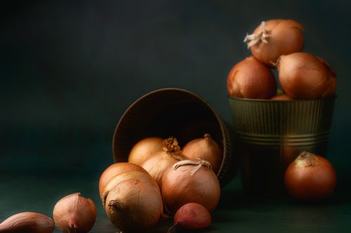 Free A collection of fresh onions in rustic metal buckets on a dark background. Stock Photo