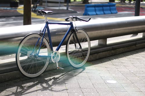 Free Blue Bicycle Parked Beside the Metal Railing Stock Photo